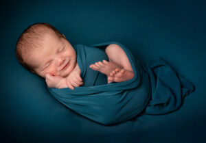 Sweet breastfed baby wrapped in comfy blanket
